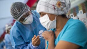 Una enfermera aplica una dosis de la vacuna desarrollada por Sinopharm de China contra el COVID-19 durante una campaña de vacunación de trabajadores de la salud en medio de la pandemia del nuevo coronavirus, en Ate, un distrito de Lima, el 19 de febrero de 2021. (Foto: Ernesto Benavides / AFP )